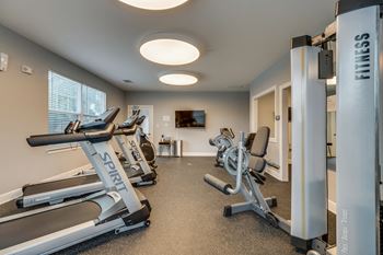 the gym has cardio equipment and treadmills at the enclave at woodbridge apartments